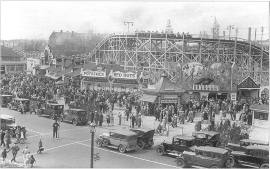 A train of ecstatic passengers on the Sunnyside Flyer roller-coaster roars by - photo 2