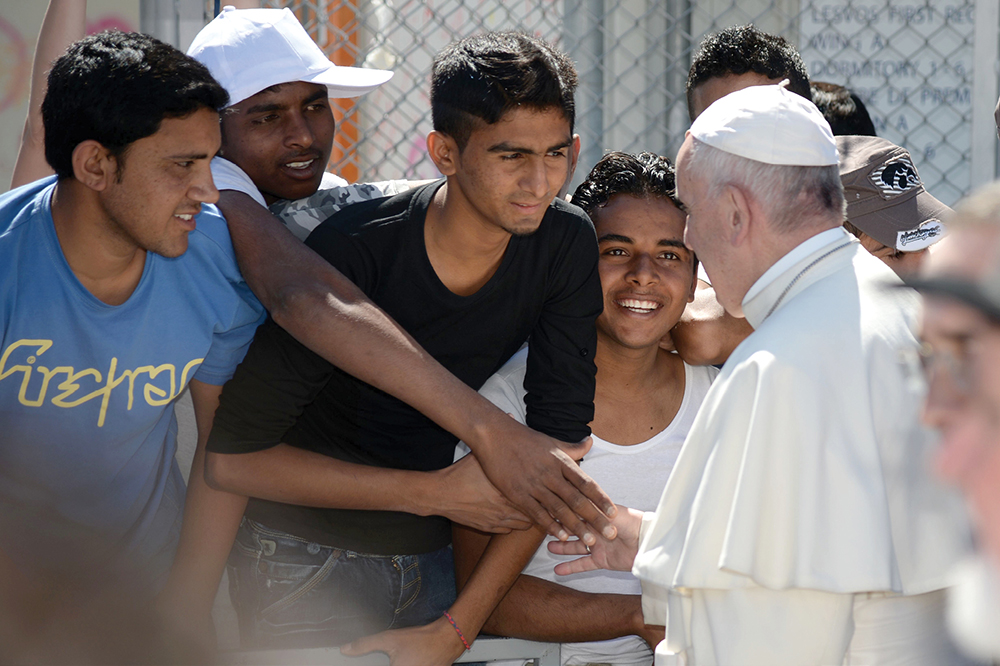 Pope Francis head of the Roman Catholic Church greeted refugees during his - photo 3