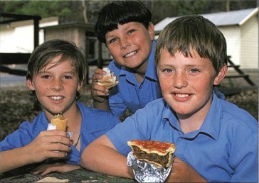 Schoolboys eating a typical lunch a homemade Vegemite sandwich a factory-made - photo 3