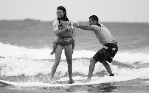 The author with his wife Nicole and a local participant at a Surfers Healing - photo 3