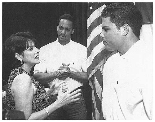 Juan Gonzales center and teammate Ivan Rodriquez talk with Puerto Ricos - photo 2