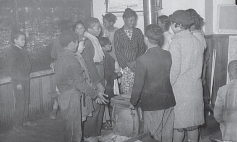 At their black-only school children gather to warm themselves around a stove - photo 4