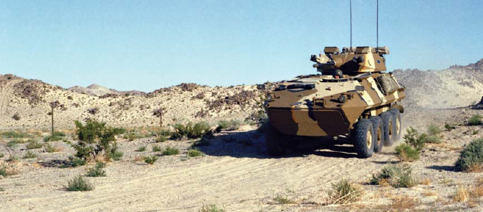 An LAV-25 wearing a distinctive four-pattern desert camouflage scheme moves - photo 2