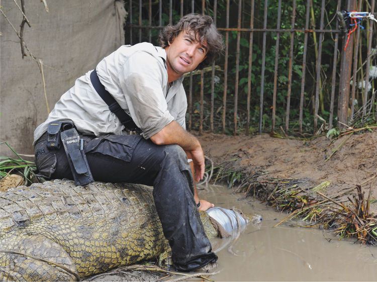 Talking to camera while sitting on the back of the bigger of the two crocs that - photo 16