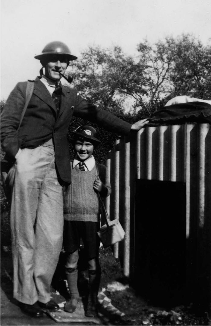 Pictured by the family Anderson shelter these two still carry their gas masks - photo 1