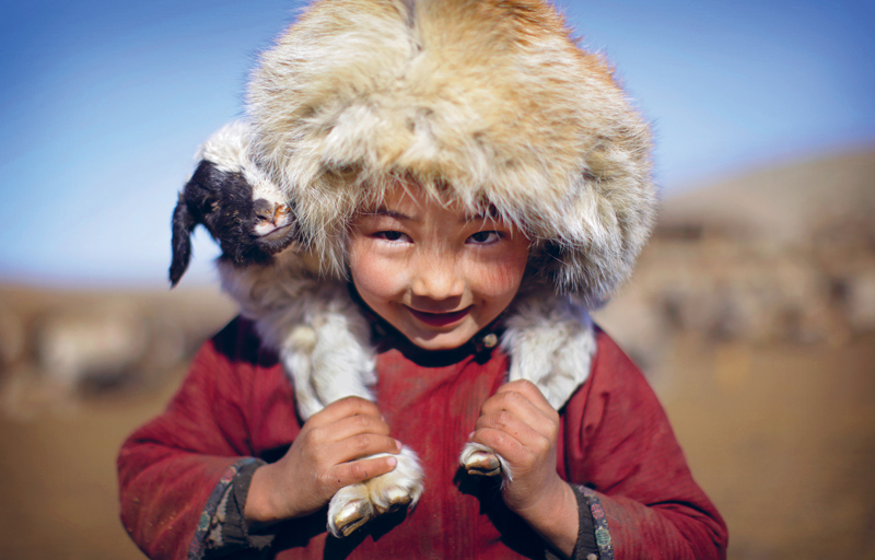 Mongolian boy carrying a lamb TIMOTHY ALLENGETTY IMAGES Why I Love Mongolia - photo 5