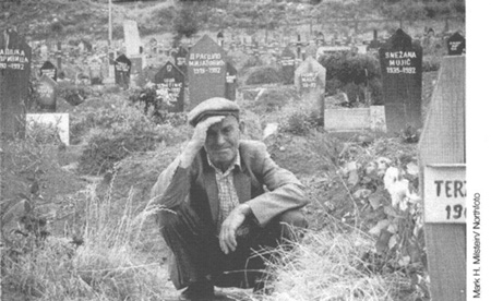 A Bosnian man mourns the loss of his wife and daughter at the Lion Cemetery - photo 5