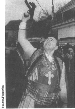 Serb paramilitary leader Arkan Zeljko Raznatovic fires a machine pistol in - photo 12