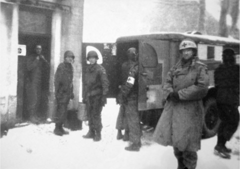 A blurred image of medics of the 101st Airborne at work inside Bastogne as - photo 11