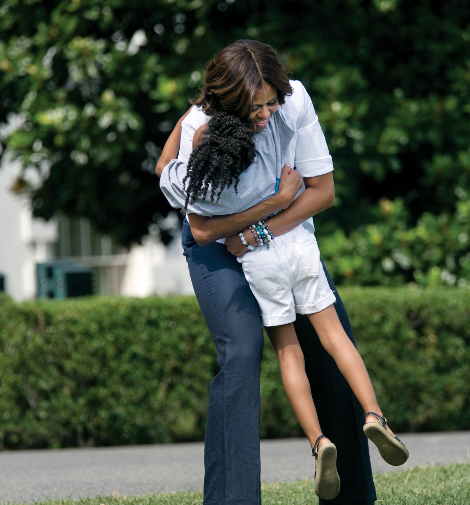 President Barack Obama and First Lady Michelle Obama share a moment on the - photo 4