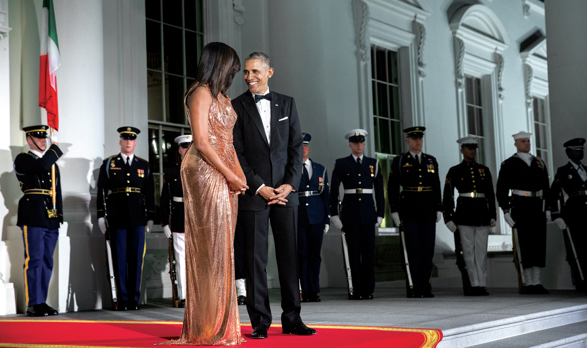 President Barack Obama and First Lady Michelle Obama share a moment on the - photo 5