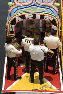 Mariachis playing in the traditional trajineras of Xochimilco Facade of - photo 6