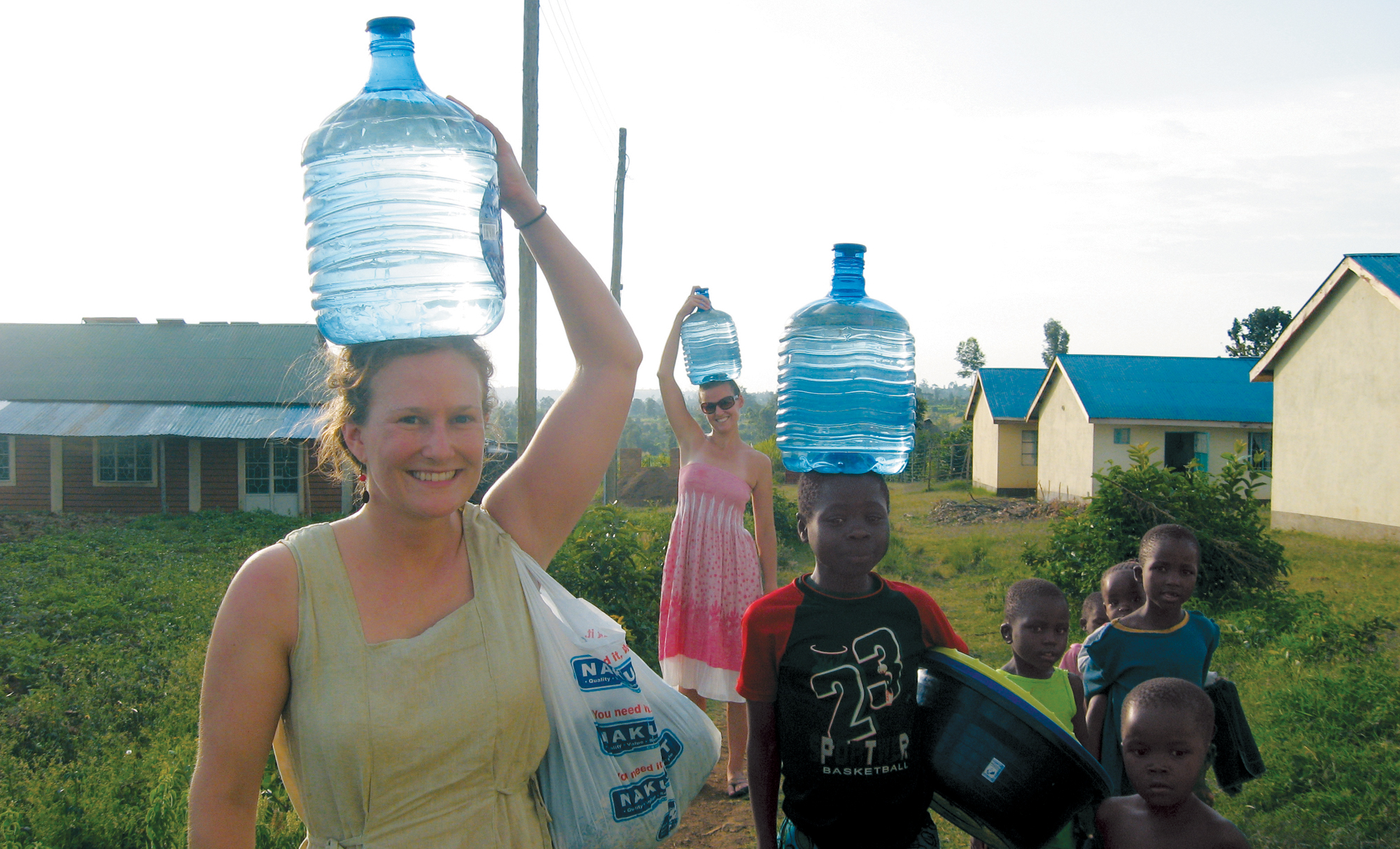 Brooke Baxter left carrying water with children in Lwala and with her - photo 25