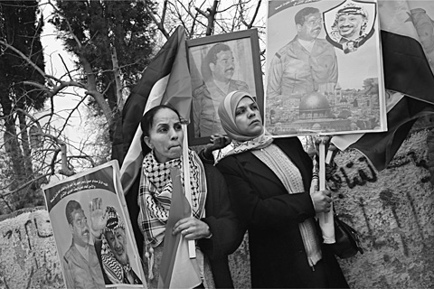 8 Palestinian women demonstrate with Palestinian and Iraqi flags and portraits - photo 10