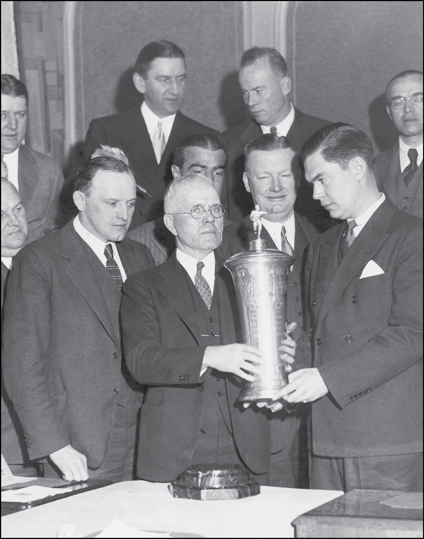 Joe Carr with glasses hands the 1934 championship trophy to Jack Mara as Tim - photo 2