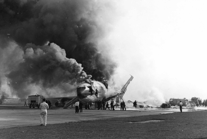 While the aircraft burns a fireman tries in vain to enter the cabin via a - photo 19