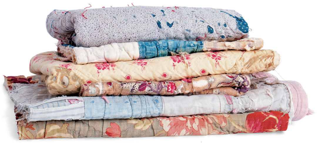 A pile of old patchwork quilts ready to be used as the foundations for collage - photo 10