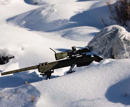 A US Marine scoutsniper dressed in overwhites for winter camouflage prepares - photo 2