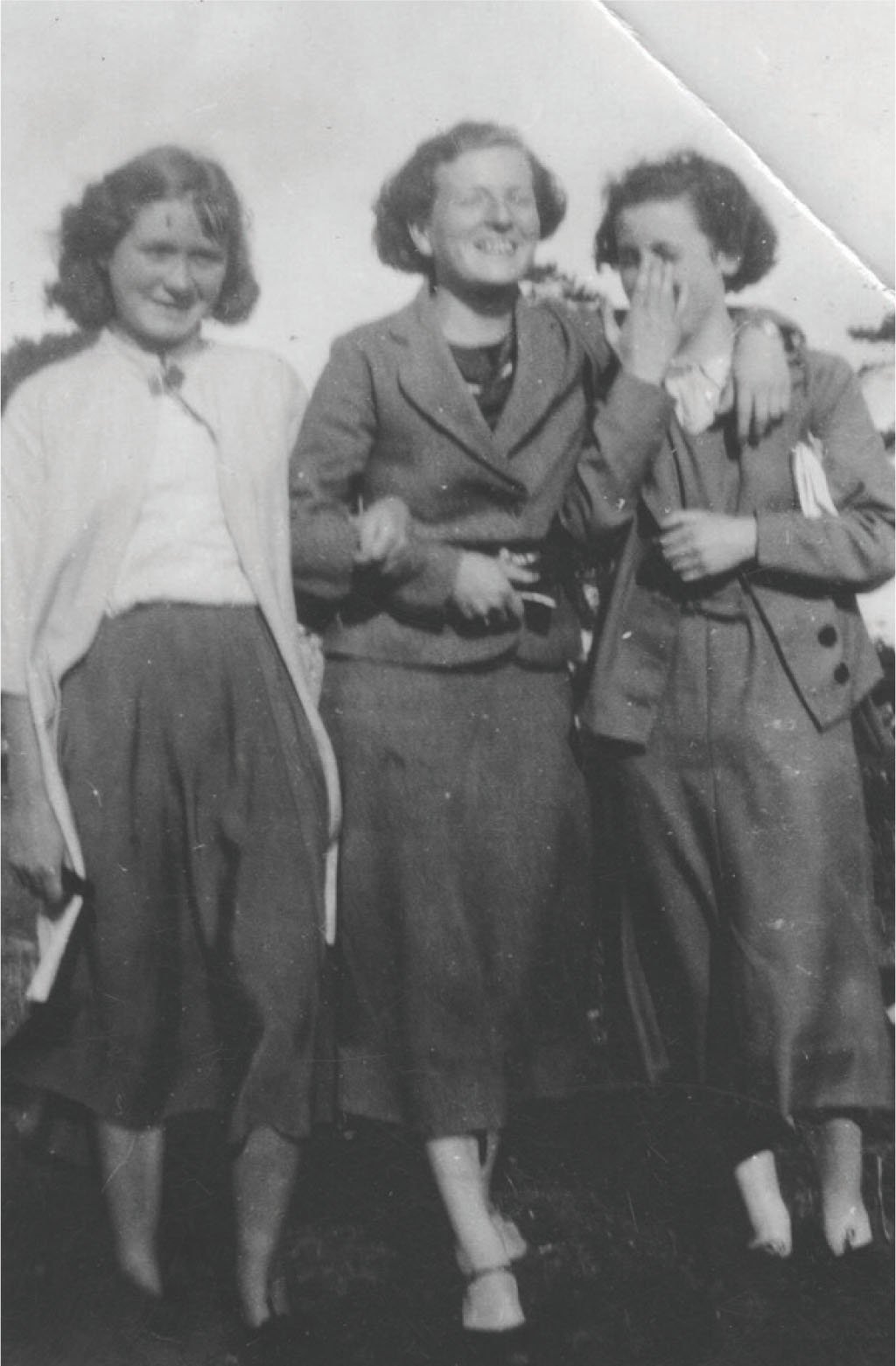 Three young women wearing mid-calf length woollen skirts with cropped blazers - photo 5