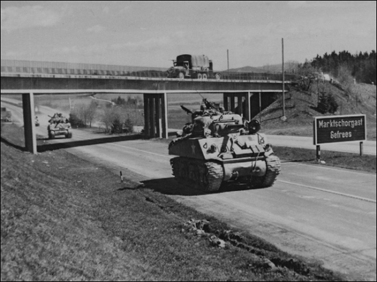 Sherman tanks of the 11th Armored Division roll down an autobahn in eastern - photo 3