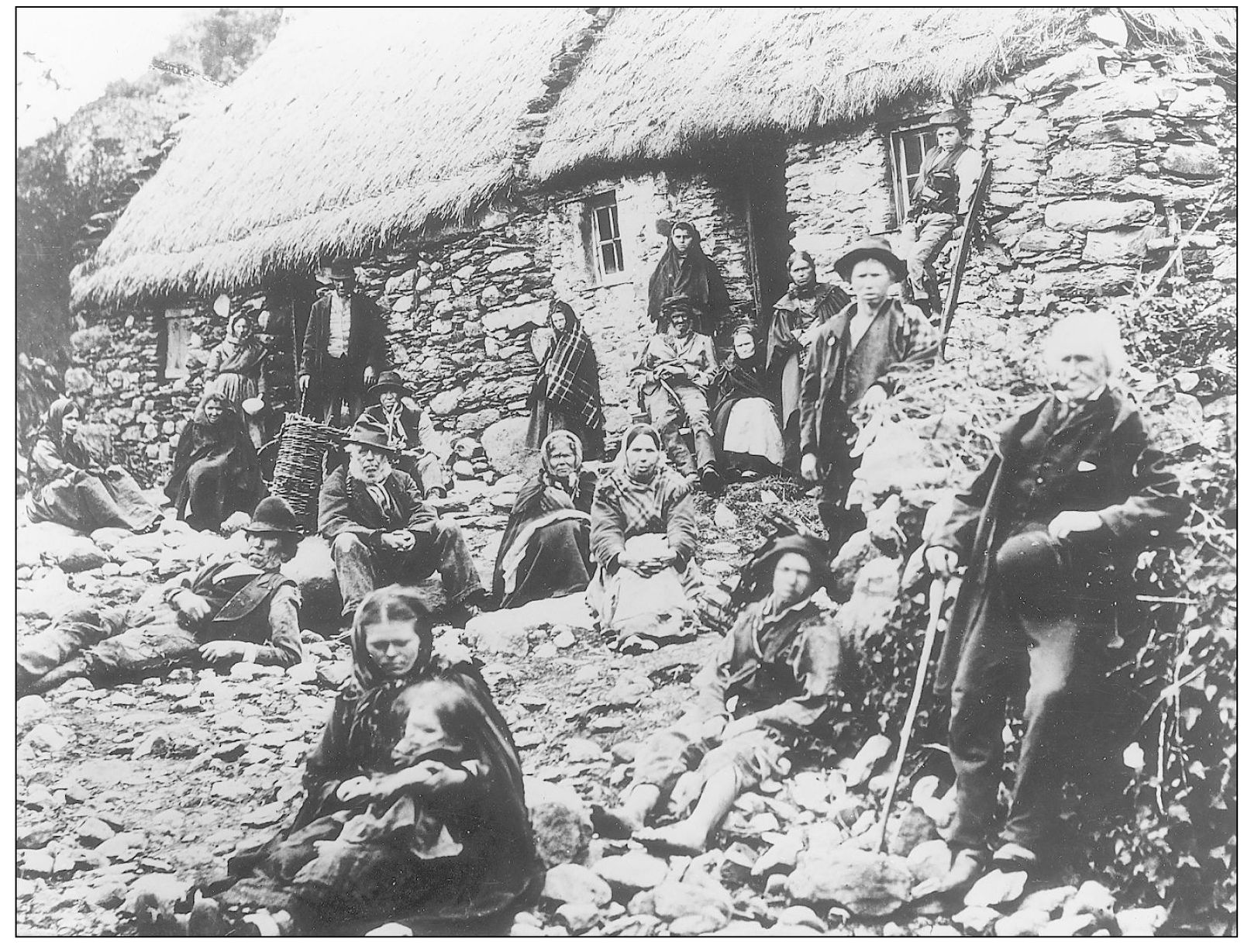 Irish peasants pose outside a thatch-roofed cottage in the 19th century The - photo 7