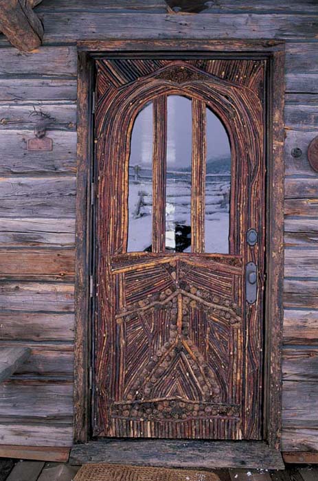 A handcrafted twig mosaic door is punctuated with pinecones A side table - photo 4