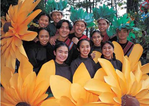 Yellow daisy flower teenagers about to join the street parade at the - photo 1