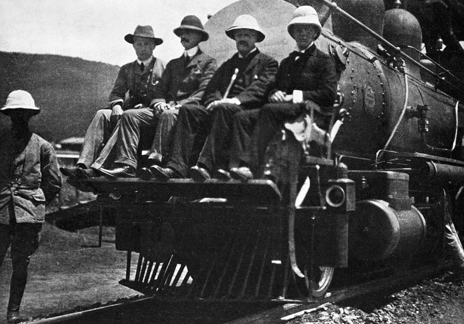 Sitting on the cowcatcher of his train in East Africa are left to right - photo 30