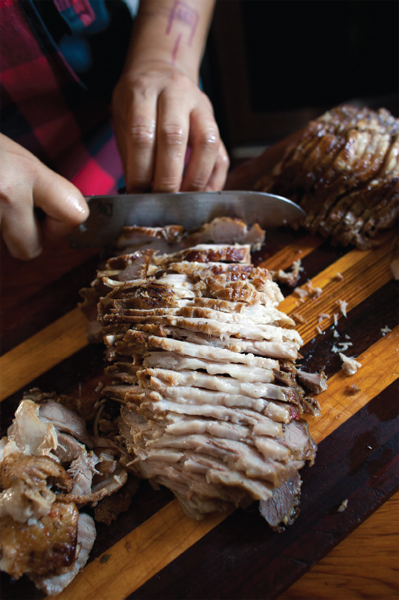 Joydah Bernardo slices Braised Pork Shoulder for the table Sarah Jane Sanders - photo 4