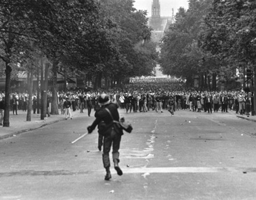 A policeman throws tear gas to disperse crowds during student riots in Paris - photo 30