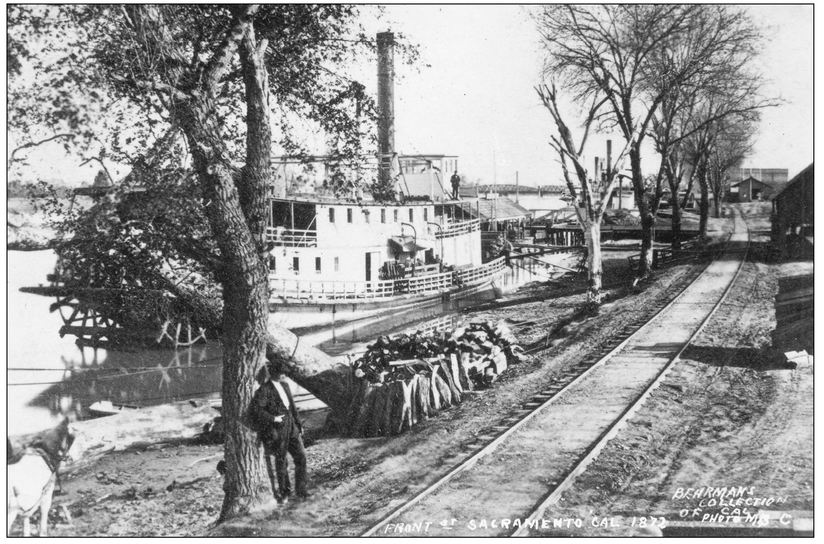 A steamboat is docked along the riverfront near the foot of K Street around - photo 8