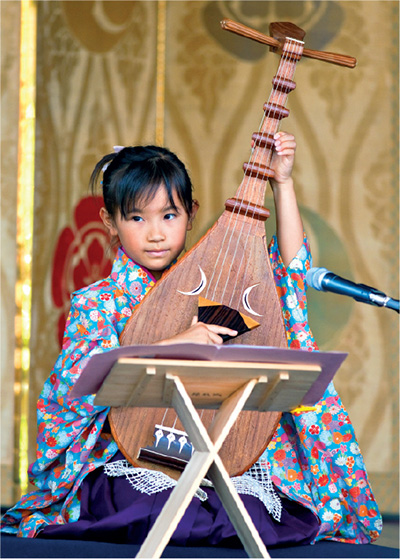 A performance of the Japanese biwa lute at Yasaka Shrine A chigo sacred - photo 10