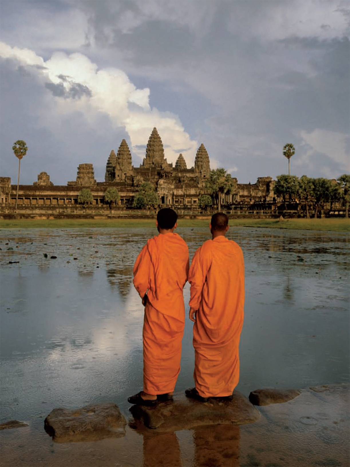 Two novice monks gaze across the moat at the 12th-century Khmer Hindu temple of - photo 5