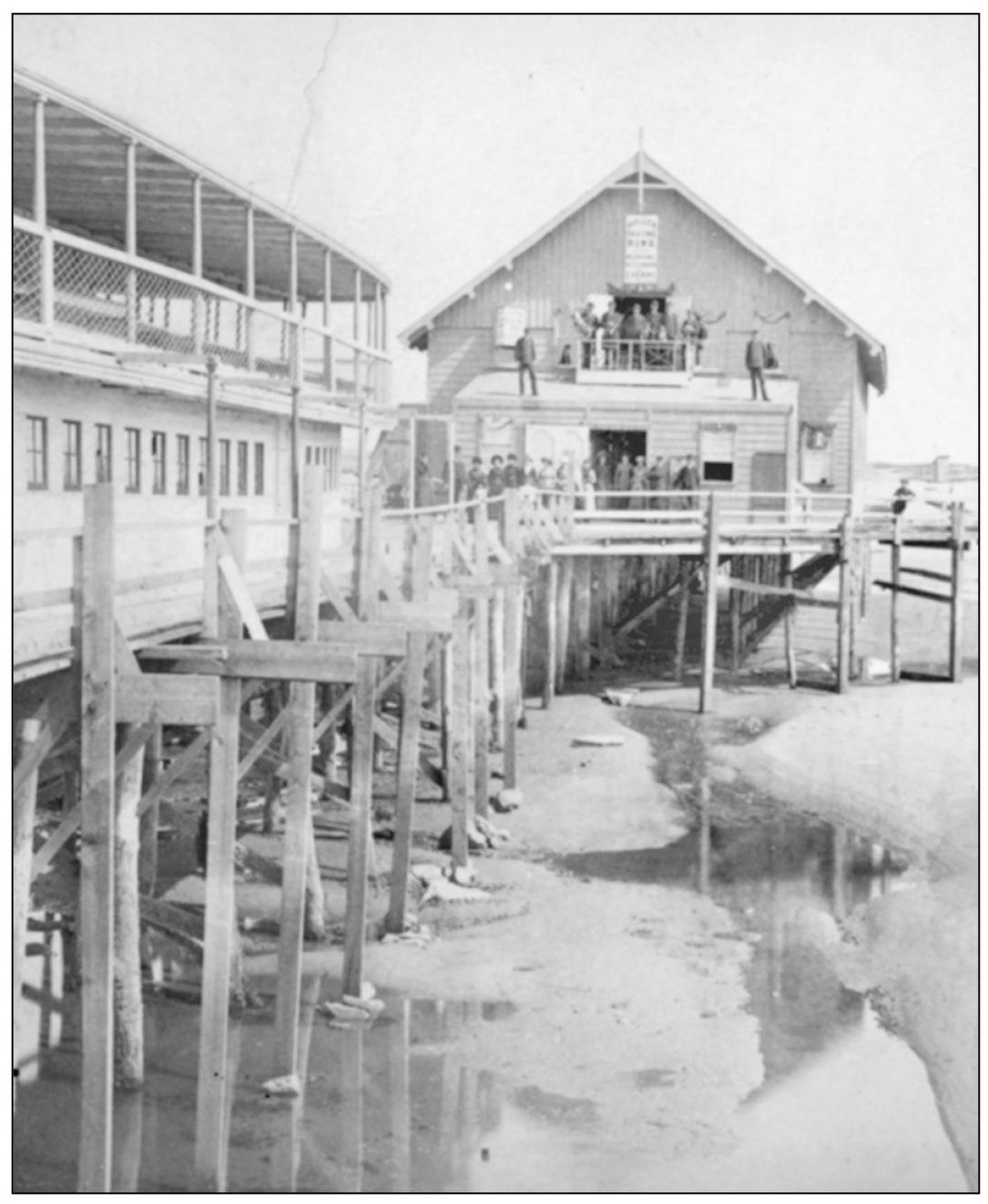 The porch of the Roller Skating Rink accommodates many people possibly waiting - photo 8