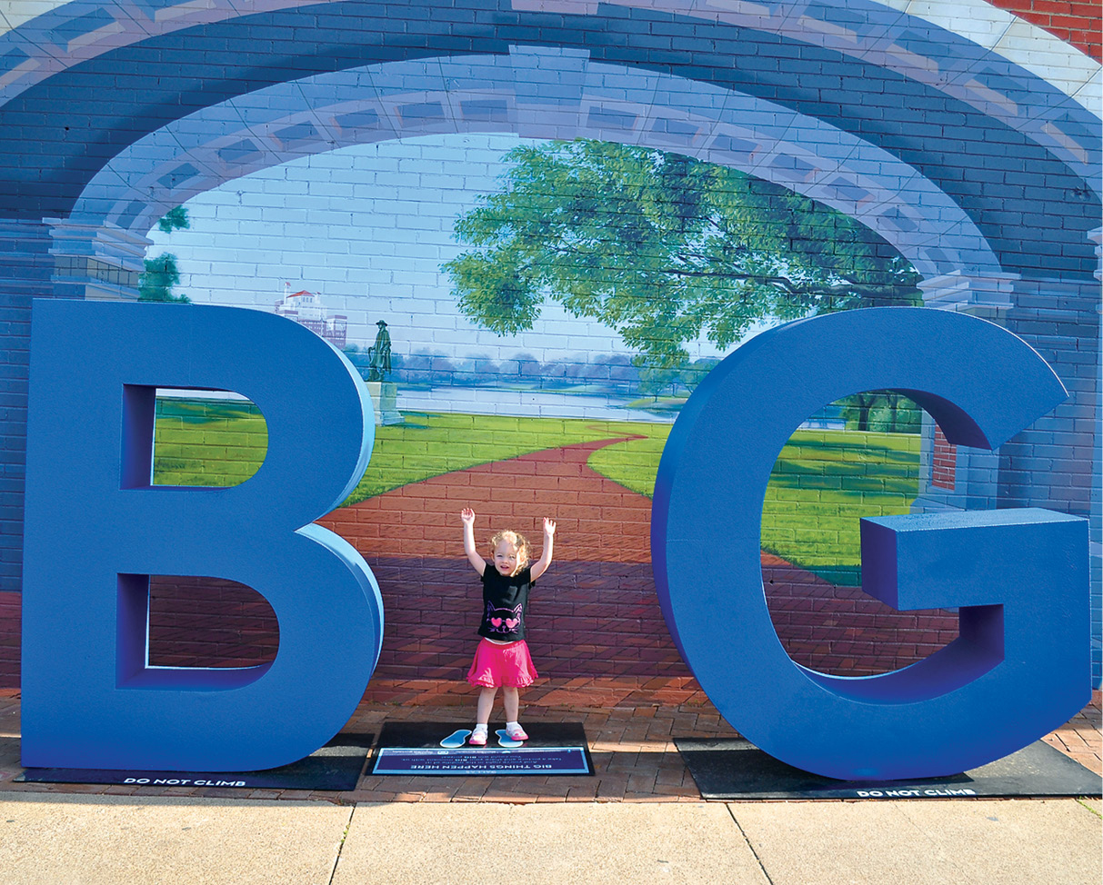 A little girl forms the I in Dallass Big Things Happen Here logo before a mural - photo 16