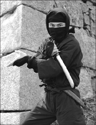 Ninja with sword A member of the Iga-Ueno ninja re-enactment society poses for - photo 3