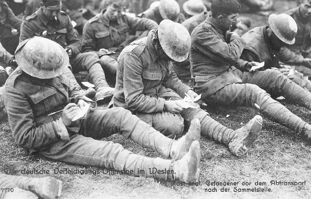 Men filling out a card which will be sent to England informing loved ones of - photo 16