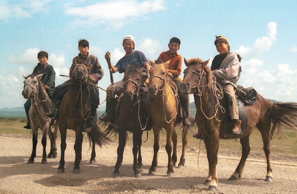 At the turn-off to Erdenet Five boys dashed their horses up the prairie for a - photo 7