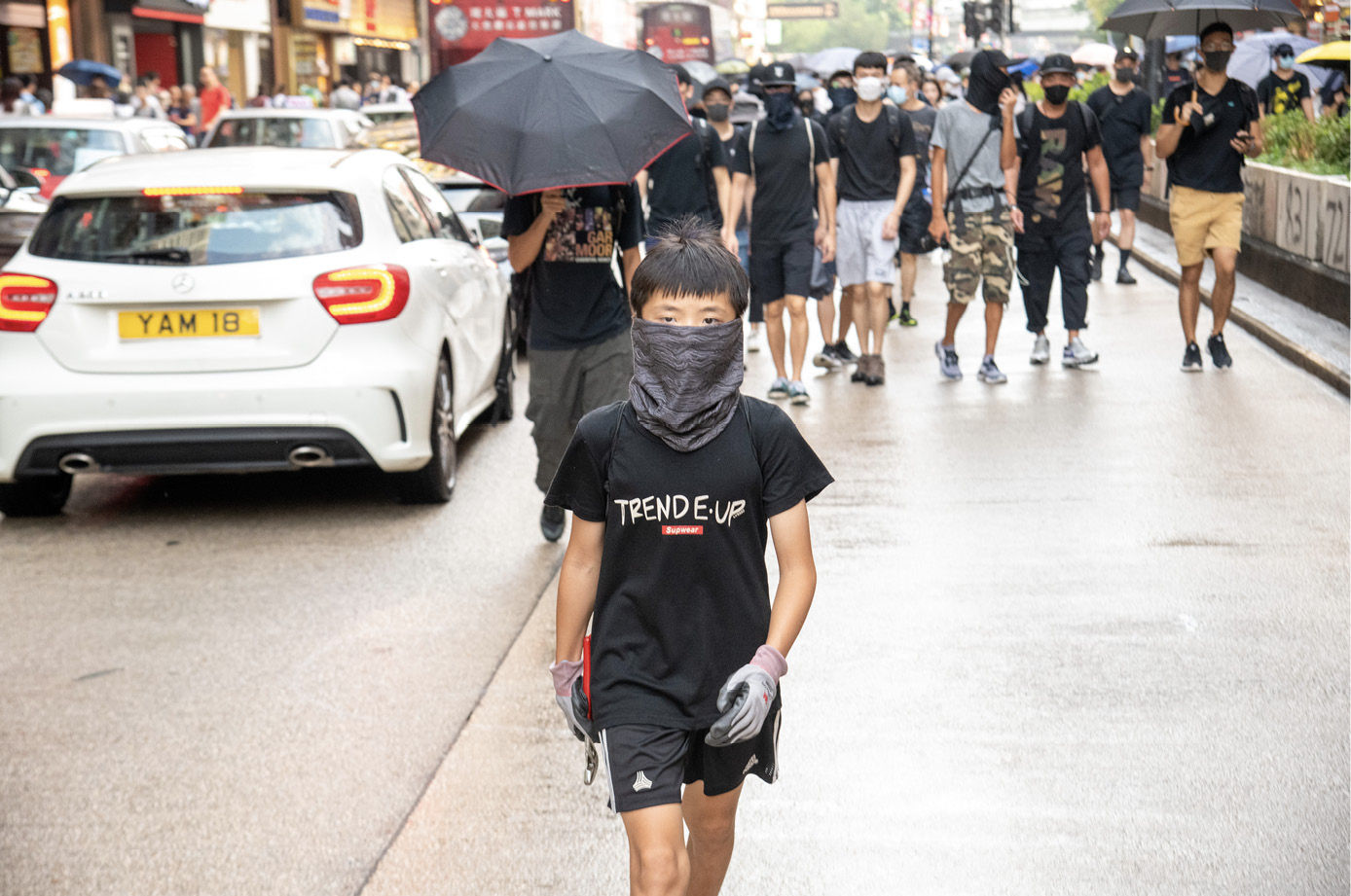 A young protester marches down Nathan Road during a massive pro-democracy - photo 7