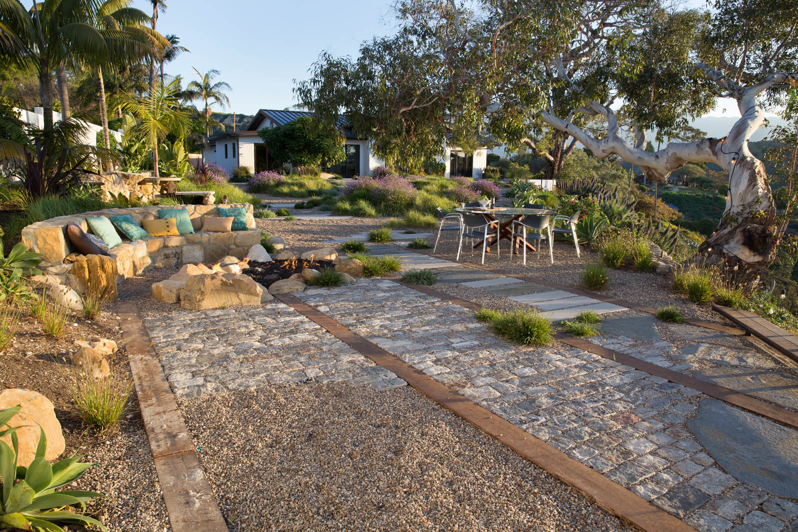 A fieldstone bench does double duty as a retaining wall and as firesideseating - photo 12