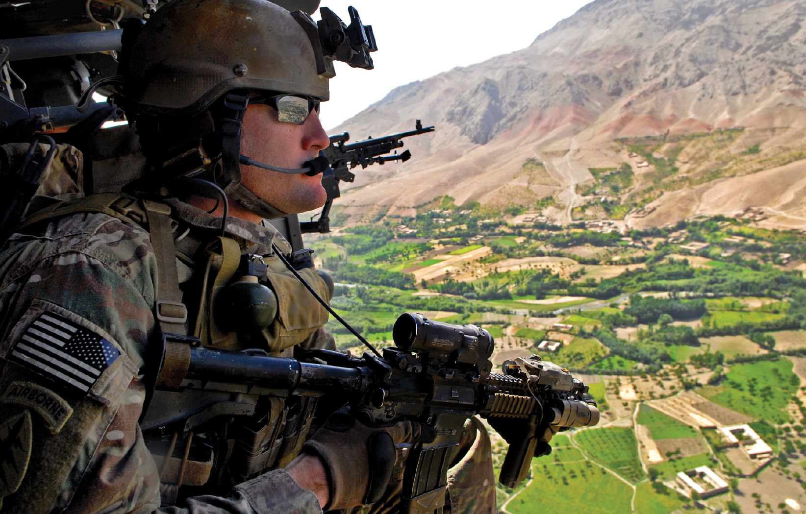 A US Army Green Beret surveys Uruzgan Province below him from a UH-60 - photo 2