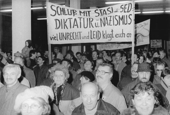 A picture of East Germans protesting outside the Stasi building in Berlin The - photo 3