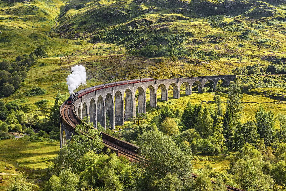 A steam train runs across the majestic Glenfinnan Viaduct on the West Highland - photo 4