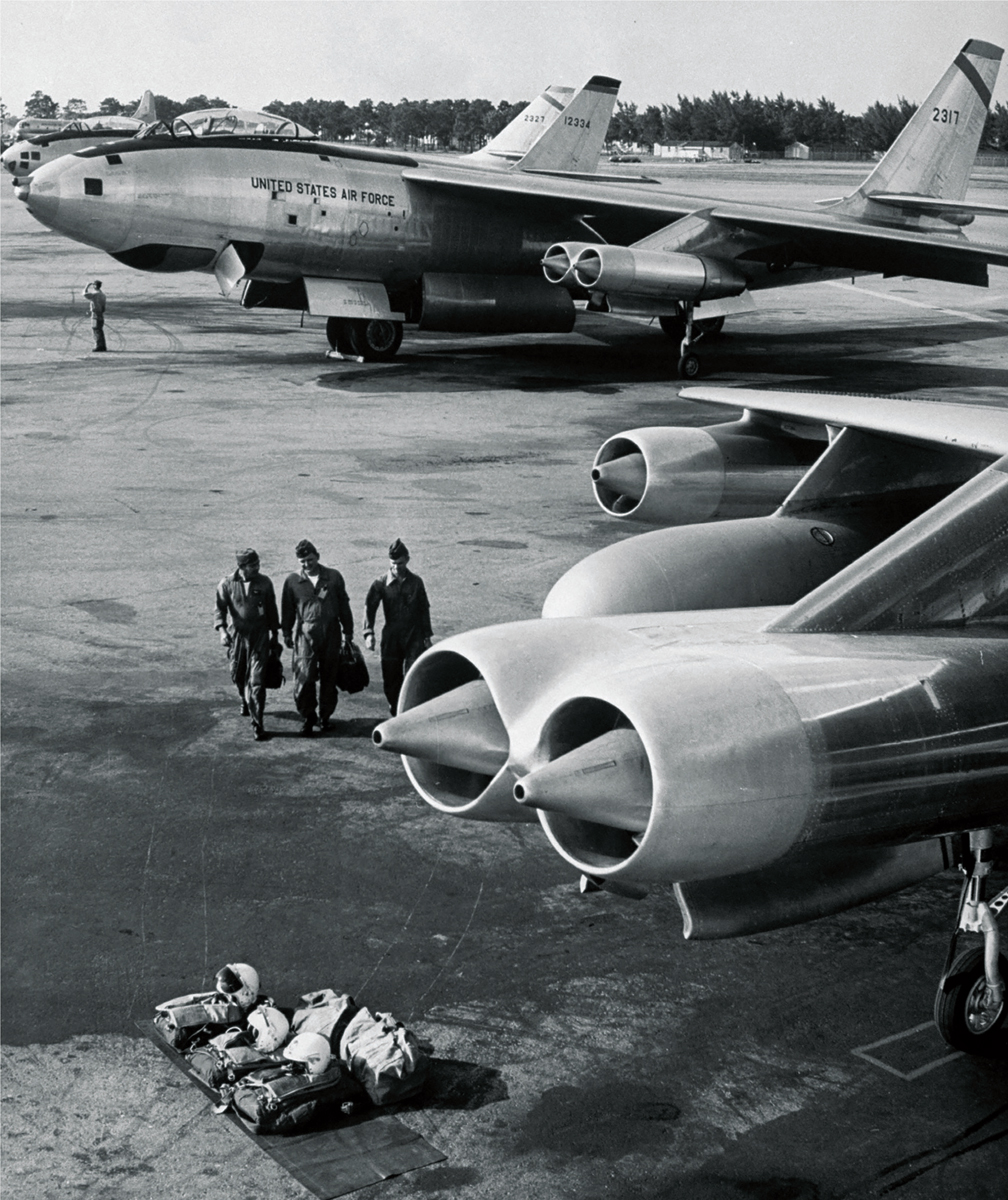 The three-man crew of a Boeing B-47E Stratojet walk out to their aircraft The - photo 6