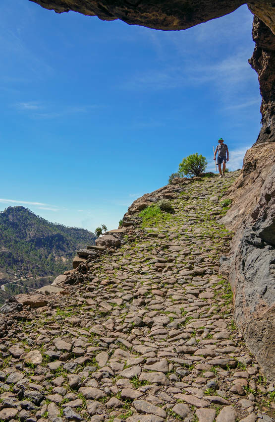 Rock overhangs a splendid paved path high above Cruz Grande Stage 17 - photo 7