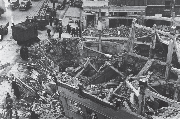 12 November 1940 Workmen and rescue services work on the bombed remains of - photo 13