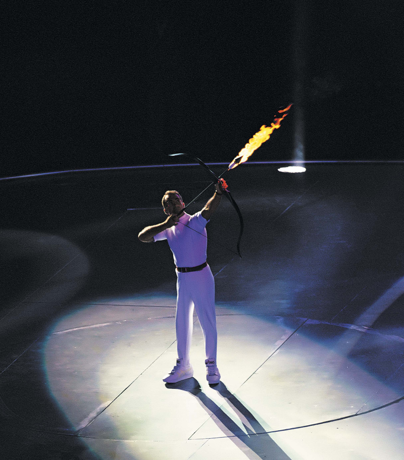 Paralympic archer Antonio Rebollo draws back a flaming arrow to light the - photo 2