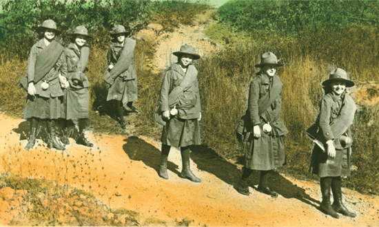 Early Girl Scouts carry bedrolls over their shoulders while backpacking 1917 - photo 8