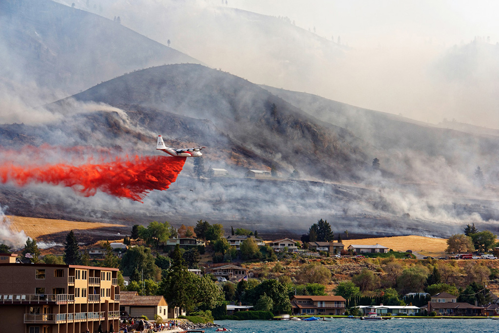 An air tanker drops fire retardant to slow the advance of the Chelan Complex - photo 2