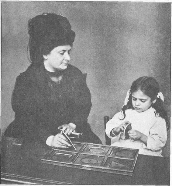 DR MONTESSORI GIVING A LESSON IN TOUCHING GEOMETRICAL INSETS THE MONTESSORI - photo 1